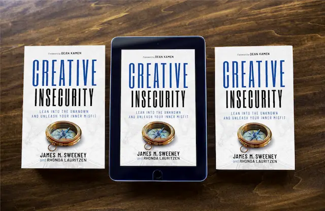 Creative Insecurity by James M. Sweeney - an entrepreneurship book - shows both the print and ebook covers on a wooden table