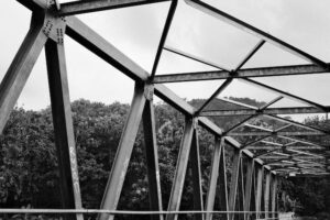 Photo by Abdullah Ammar on Unsplash - bridge showing triangles in architecture. This is like The Contrarian's Trifecta. 